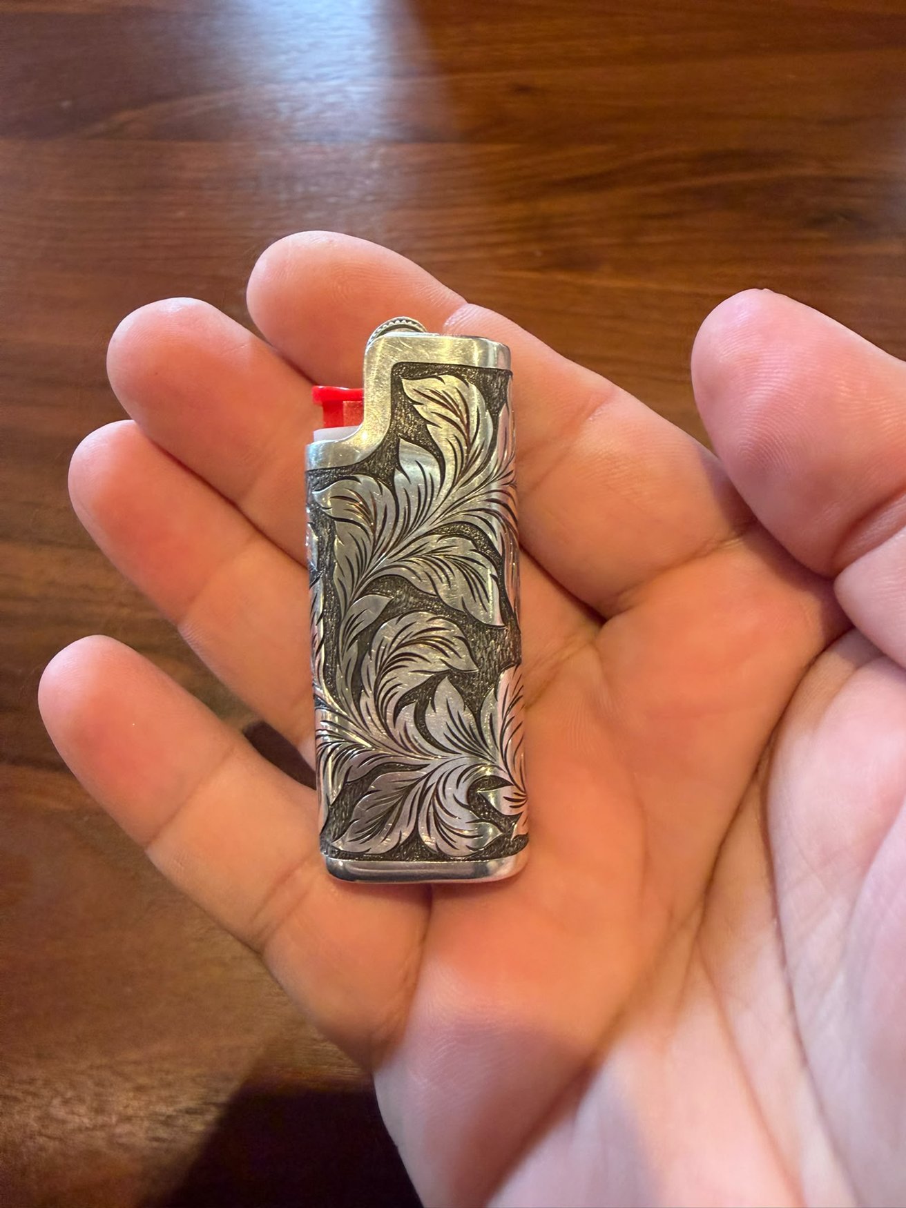 Back of the engraved lighter case with flowing leaf scrollwork