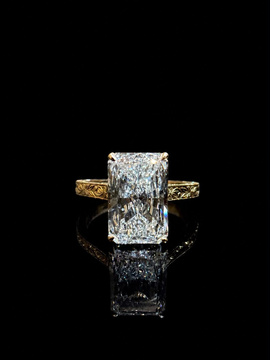 Hand-engraved yellow gold ring with a radiant-cut stone
